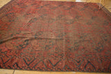 Geometric serrated border in navy blue and charcoal on a madder red vintage Ersari rug.