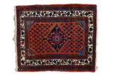 Vintage Engelas square rug with a navy diamond medallion on a rusty red field of repeating boteh patterns.