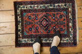 Small vintage Persian Engelas rug on a wood floor illustrating its real-life scale.