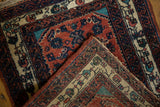 Folded corner of the vintage Engelas rug reveals the hand-knotted construction and colorful low pile.