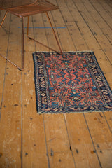 Vintage Lilihan rug corner detail, blush field, navy border, visible knot head wear.