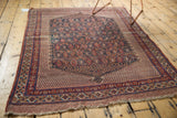 Antique Afshar rug corner, visible light loss on fringe, red and blue geometric borders.