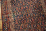 Intricate geometric borders and interconnected boteh field of the antique Afshar rug in navy and madder root red.