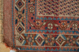 Madder red, navy, ivory geometric patterns and light wear on antique Afshar rug's corner.
