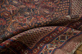 Antique Afshar rug: hand-knotted texture, madder red, navy, ivory patterns, and fringe.