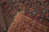 Antique Afshar rug corner reveals intricate boteh pattern, madder red foundation, and natural fringe.