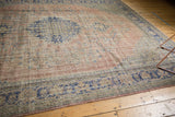 Distressed vintage Oushak carpet border with faded blush and cobalt blue vinery.