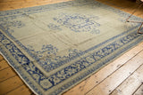 Textured cobalt blue border and pale celadon field of a distressed vintage Oushak rug.