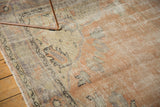 Distressed texture on vintage Oushak carpet, with pale apricot, beige, and faded blue.