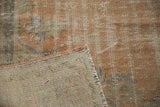 Textured distressed apricot pile and tightly hand-knotted beige foundation of a vintage Turkish Oushak rug.