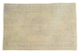 Distressed vintage Oushak carpet, faded beige field, Rococo medallion, blue scrolling border, 6' x 9'4