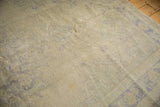 Distressed beige Oushak pile texture with faint foundation showing through.