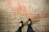 Distressed texture of a vintage Oushak carpet in dusty blush terra cotta and faded denim.