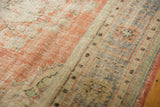 Distressed Oushak pile texture in dusty blush, faded denim, ivory, and seafoam tones.
