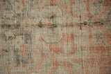 Vintage distressed Oushak pile, showing visible wear and muted dusty blush terra cotta hues.