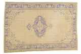 Distressed Oushak carpet, pale ivory field, faded blue scalloped medallion and leaf border.