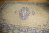 Distressed Oushak rug lower corner with faded cobalt blue meandering palmette border.