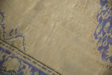Distressed pale antique ivory field texture of the vintage hand-knotted Oushak rug.