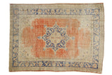 Distressed Oushak carpet with bold cobalt blue Rococo-inspired medallion on blush red field, 6'10