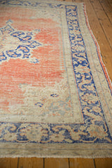 Textured distressed pale blush red field with rococo cobalt blue border.