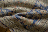 Distressed vintage Oushak carpet pile with textured knot heads and faded tones.