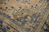 Distressed Oushak carpet pile showing even wear, cobalt blue geometric patterns, and oxidized silver tones.