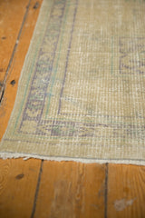 Distressed vintage Oushak runner's secured side, revealing faded blue, green, and ivory tones.