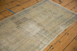 Textured, distressed pile along the secured side of a vintage Oushak runner.