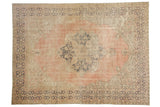 Distressed vintage Oushak carpet featuring a pale blush field, dusty navy medallion, Rococo accents, 8x10.7.