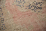 Pale blush and beige distressed Oushak pile with mostly even wear and faint foundation.