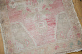 Distressed hand-knotted Oushak rug pile with even wear in pink and ivory tones.