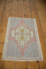 Distressed Oushak rug mat, faded dusty rose, slate gray geometric medallion.