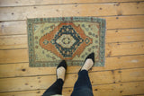 Hand-knotted Turkish Oushak rug corner with faded charcoal navy border and pale copper rust.