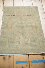 Distressed Oushak rug texture in muted beige, antique ivory, and pale seafoam.