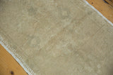 Close-up of hand-knotted Oushak rug pile showing distressed texture and even wear.