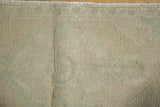 Distressed vintage Oushak rug pile texture with even wear and pale seafoam green hues.