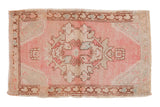 Distressed Vintage Oushak rug, pale pink and ivory Rococo medallion, floral finials, abrashes.
