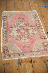 Vintage distressed Oushak rug mat corner, with geometric bronze border and pale pink.