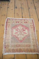 Distressed Oushak rug mat featuring geometric stepped medallion, pale red blush, ivory, sand.