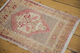 Distressed Oushak rug's fringed corner with pale cochineal red floral main border.