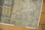 Corner of Vintage Distressed Oushak geometric rug showing stepped border and fringed edge.