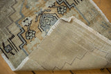 Hand-knotted foundation and reverse side markings of a vintage distressed Oushak rug.