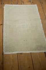 Distressed Oushak rug pile showing pale ivory texture, even wear, and secured side.
