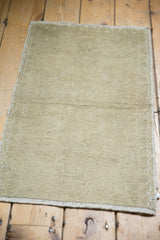 Textured hand-knotted Oushak rug pile in pale antique ivory with even wear.