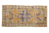 Dusty gold Distressed Oushak runner with royal blue medallion, seafoam green and ivory leaves.