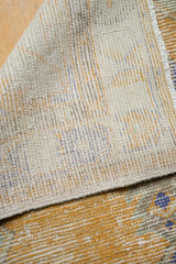 Underside of hand-knotted Oushak runner showing tight weave with subtle colorful threads.