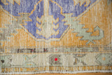 Distressed Oushak rug texture, even wear, faint foundation, dusty gold, royal blue, seafoam green.