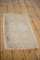 Distressed Oushak rug mat's secured side edge, featuring even wear and faded ivory blush tones.