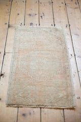 Full view of the vintage distressed Oushak rug, highlighting muted ivory and faded blush red tones.