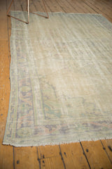 Overhead view of the distressed vintage Oushak carpet, highlighting worn pile and muted colors.